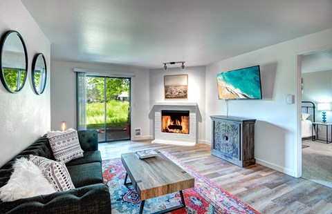 Kirkland Apartments for Rent - Spacious Living Room With Modern Wood Floors and Cozy Fireplace